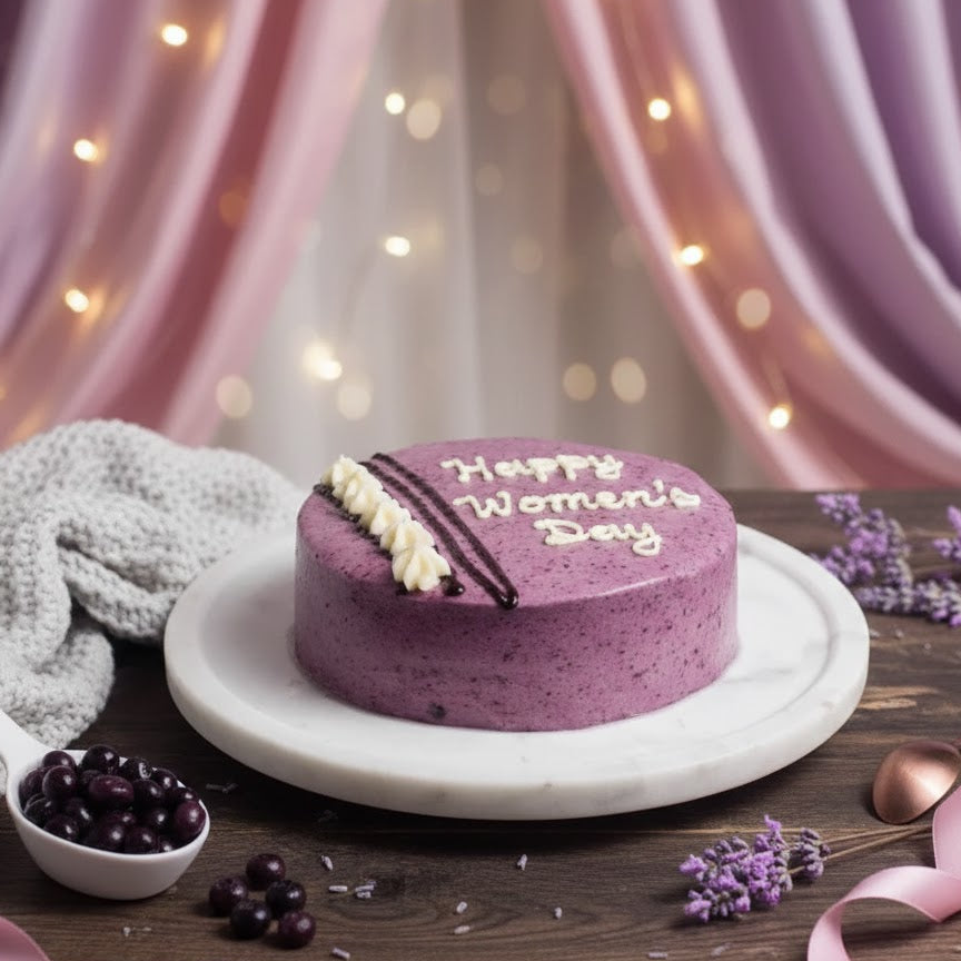 Purple cake with 'Happy Women's Day' on a wooden table with decorative elements.