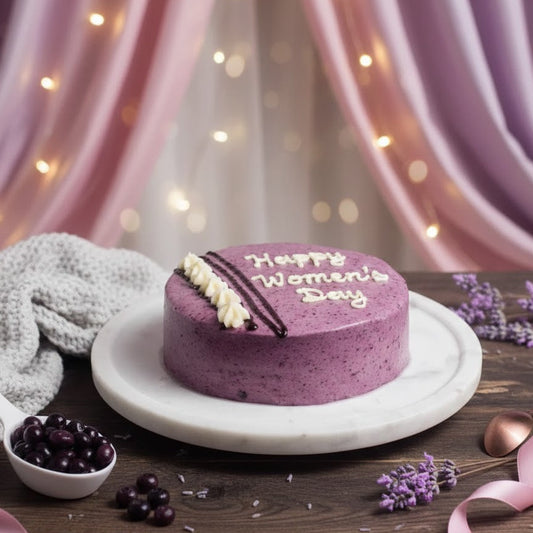 Purple cake with 'Happy Women's Day' on a wooden table with decorative elements.